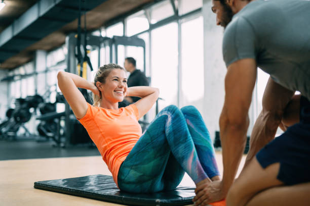 istock Personal trainer assisting woman lose weight 908987782