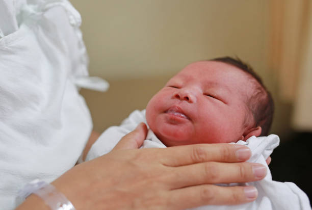 istock Mother is belching for infant baby. 908988852