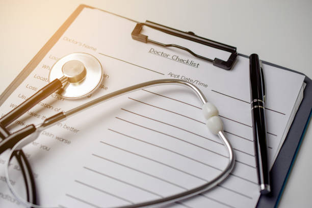 istock Doctor check list with stethoscope and pen 908989252