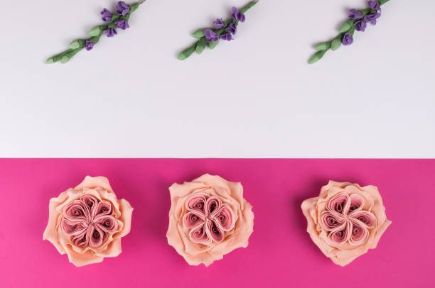 istock Pink handmade mastic flowers with green branches on white background. 908989746
