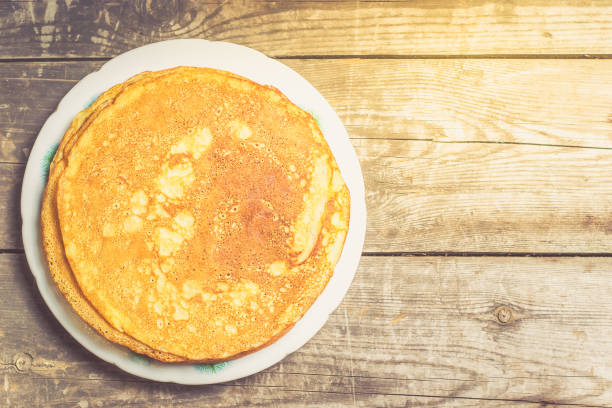 istock Fried pancakes on old wooden table. 908991900