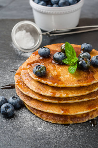 istock Stack of pancakes with fresh blueberry and caramel syrup 908993502