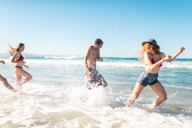 istock Group of people playing at the beach 909000006