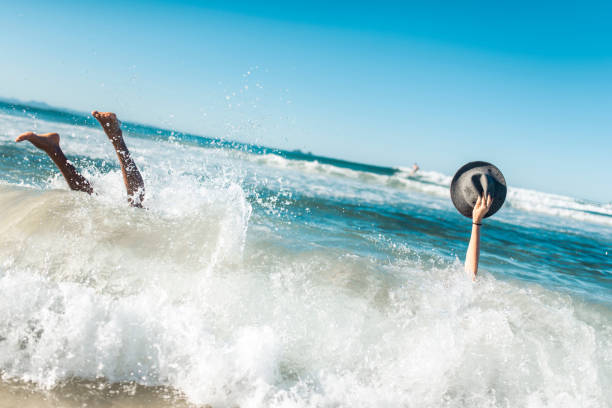 Small group of people running into the ocean
