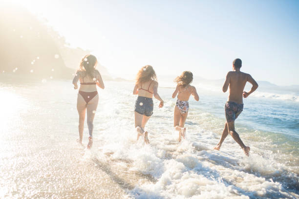 istock Friends playing and running in the ocean 909000038