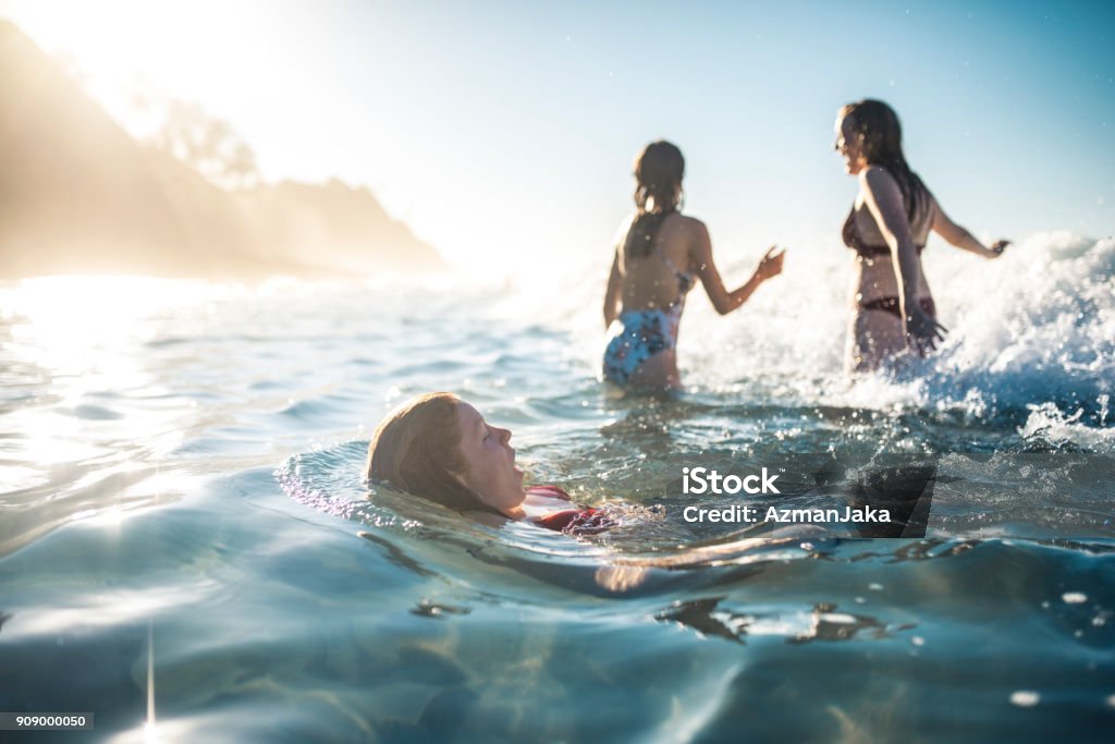Friends swimming in the ocean in summer Swimming Stock Photo
