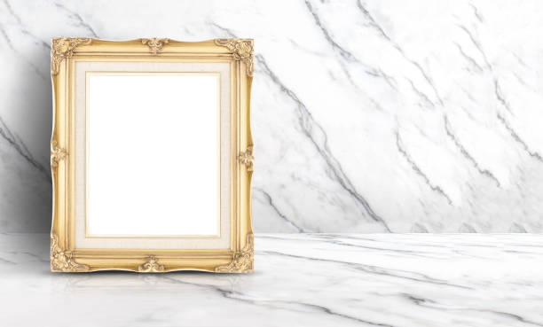 istock Empty golden vintage frame at white clean marble wall and floor background,Minimal simple style interior backdrop.mock up space for adding your text or design in banner. 909001020