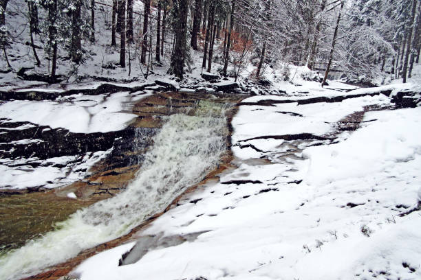 istock Stream in snowy forest of Krkonose mountains 909001778