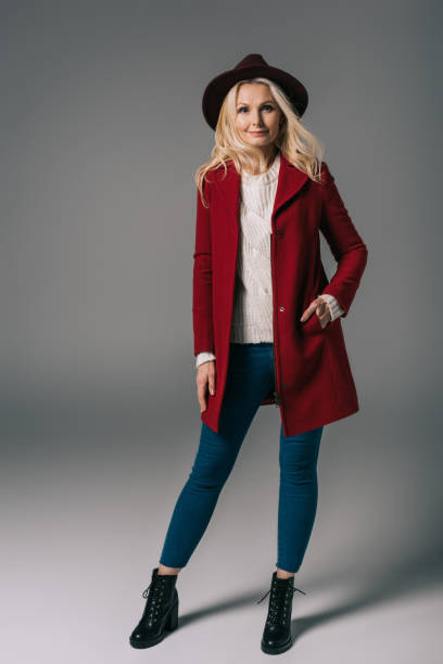istock mature woman in red coat and hat 909001936