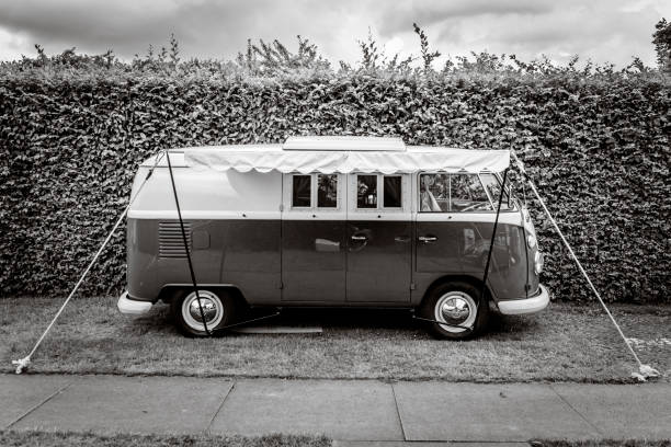 1950s Volkswagen Type 2 (T1) Transporter  Kombi or Microbus campervan with a sunblind parked in a park. The Volkswagen Transporter is a popular van to use as a camper and was delivered originally as a camper van, but many have been converted later. The car is on display during the 2017 Classic Days at Schloss Dyk in Juchen, Germany.