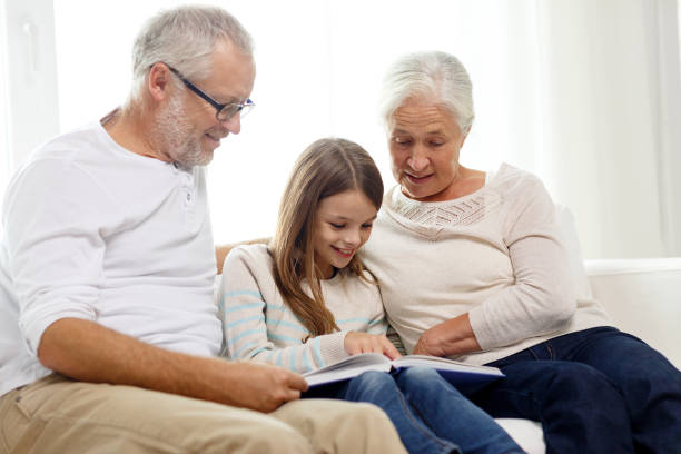 istock smiling family with book at home 909004524