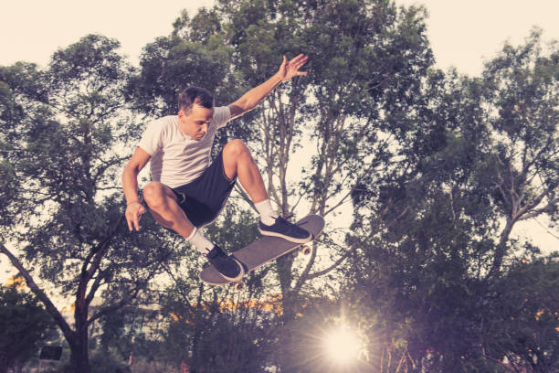 istock young American man practicing radical skate board jumping and enjoying tricks jumps and stunts in concrete half pipe skating track in sport and healthy lifestyle concept 909004610