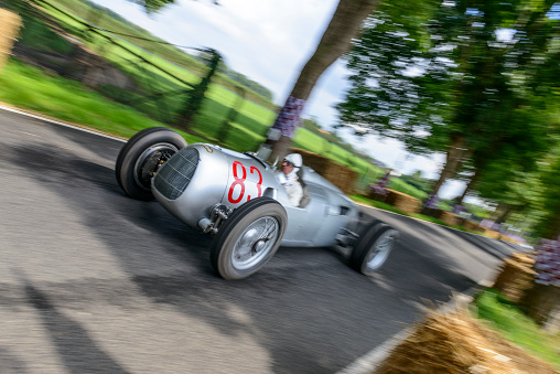 Auto Union Grand Prix Rennwagen Type C V16 driving at high speed. The Auto Union Grand Prix cars were racing for Nazi Germany in the 1930s. The car is doing a demonstration drive during the 2017 Classic Days event at Schloss Dyck.