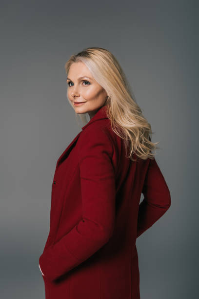 istock mature woman in red coat 909005240