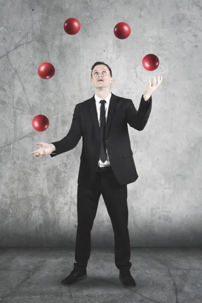 istock American businessman juggling with red balls 909005248