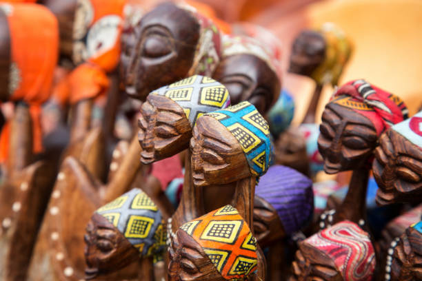African carved group of women African tribal art for sale at a market stall. This artwork is generic and widely available across markets in South Africa. carving craft product photos stock pictures, royalty-free photos & images