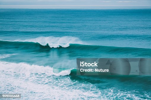 istock Crashing big wave in ocean and cloudy weather. Swell for surfing 909005668