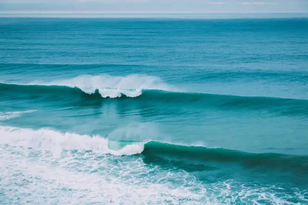 Crashing big wave in ocean and cloudy weather. Barrel waves for surfing