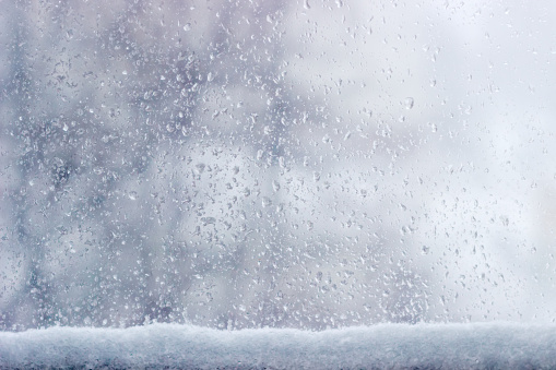 Background of the window pane during a sleet