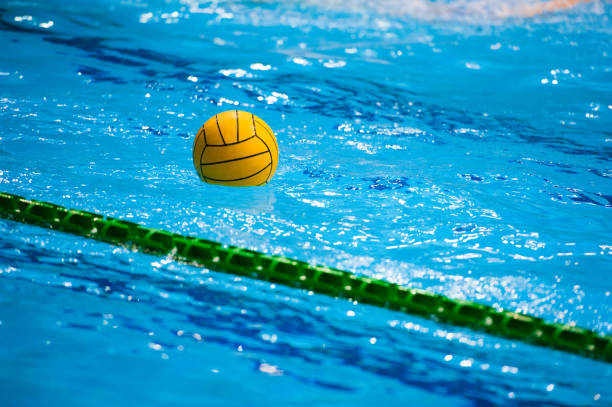 Water polo ball Water polo action in a swimming pool water polo stock pictures, royalty-free photos & images