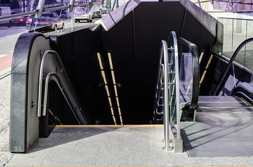 Stairs going down to a subway station in Warsaw, Poland. No people on scene.