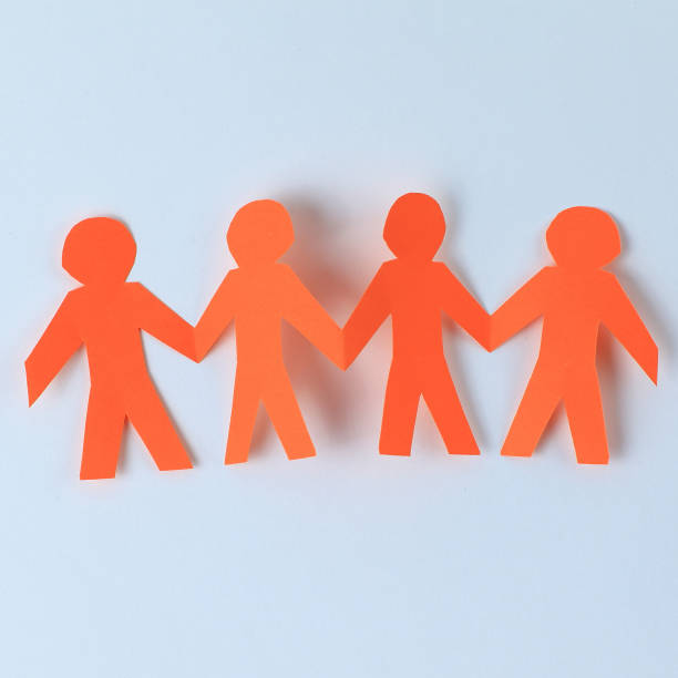 istock four paper men taking each other's hands 909016766