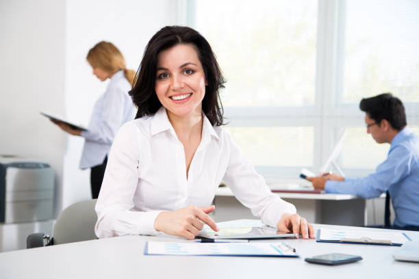 istock Businesswoman with colleagues 909017308