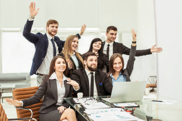 istock business team with their hands up and voting for decision-making near the desktop 909020950