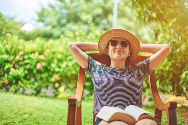 istock Young woman with book on knees 909023474