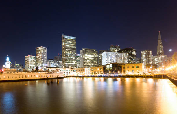 istock modern buildings near water in modern city 909023936
