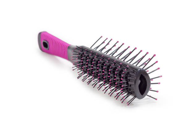 istock Hairbrush with plastic bristles closeup on a white background 909024070