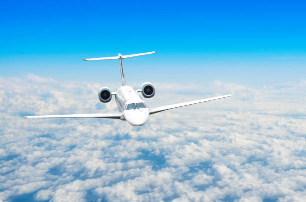 istock Airplane in the sky above the clouds flight journey sun height 909024380