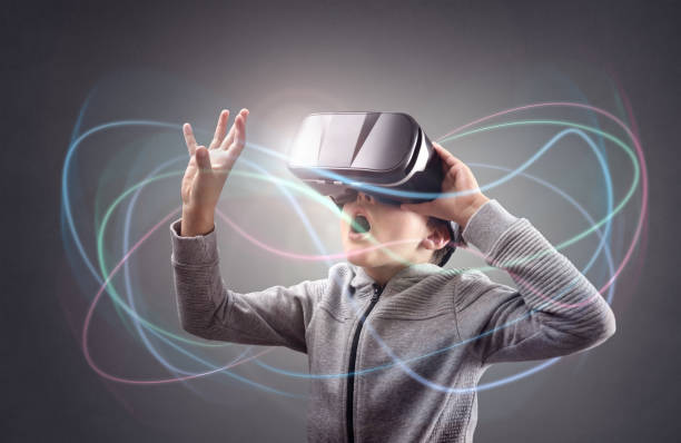 Boy experiencing using a virtual reality headset Boy experiencing using a virtual reality headset trying to touch something head mounted display stock pictures, royalty-free photos & images