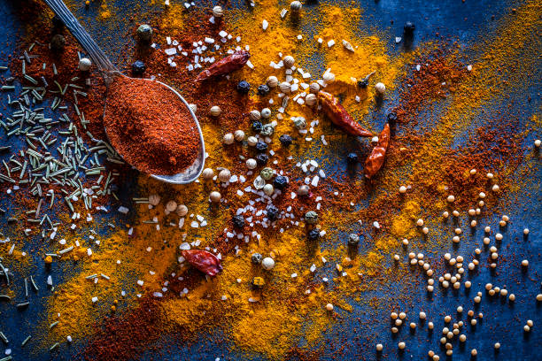 Ground spices background Top view of a bluish tint kitchen table with ground spices making a useful background. Low key DSRL studio photo taken with Canon EOS 5D Mk II and Canon EF 100mm f/2.8L Macro IS USM healthy eating color image horizontal nobody stock pictures, royalty-free photos & images