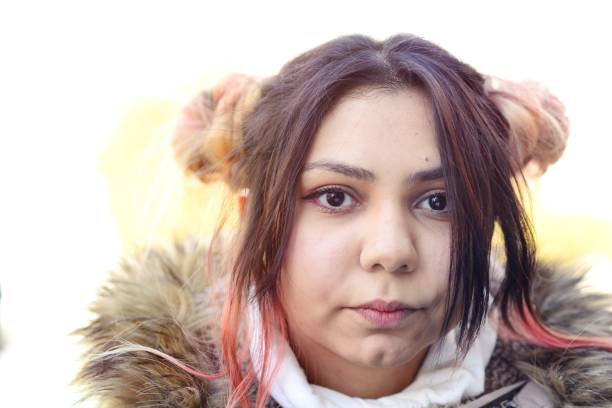 istock Young woman with pink buns 909037074