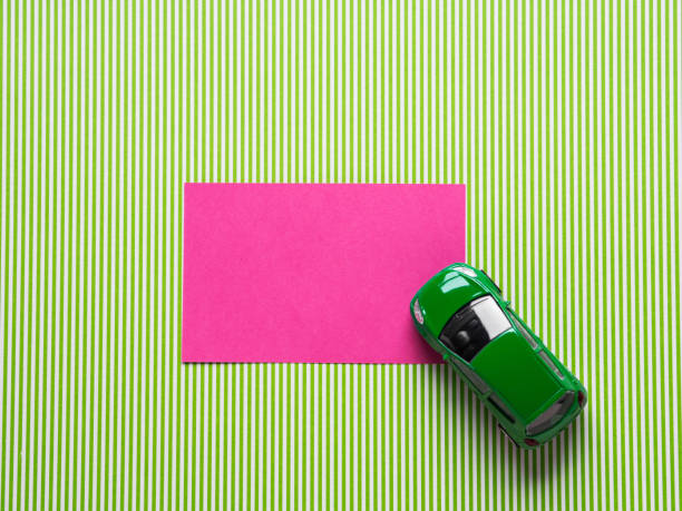 istock Pink card and green toy car 909037088
