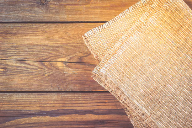 istock Linen napkin on vintage wooden kitchen table. 909037280