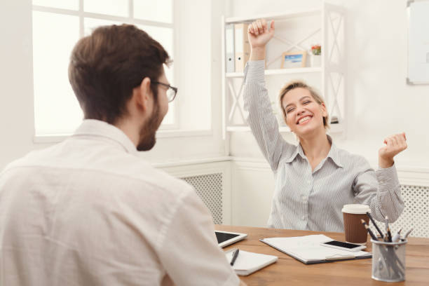 istock Young happy business partners in office with computer 909038026