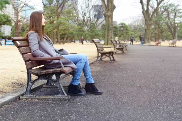 istock Young woman sitting outside 909041332