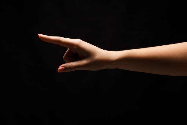istock Hand gestures - woman pointing, isolated at black 909042258