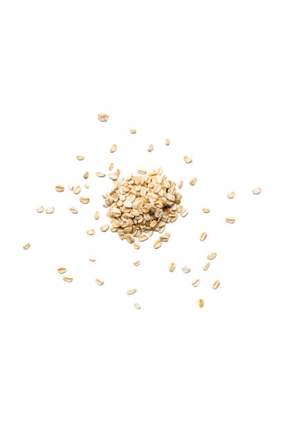 istock Organic oat flakes isolated on white background 909045340