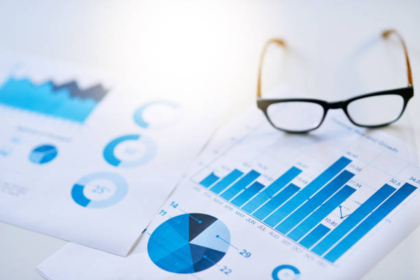 It all adds up in the end Shot of business documentation and glasses on an office desk planned economy stock pictures, royalty-free photos & images