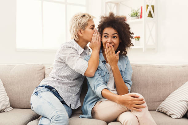 istock Young woman telling her friend some secrets 909046036