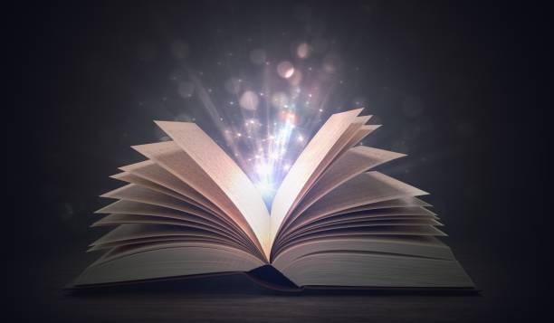 istock Open shining magic book on dark background. 3D rendered illustration. 909047776