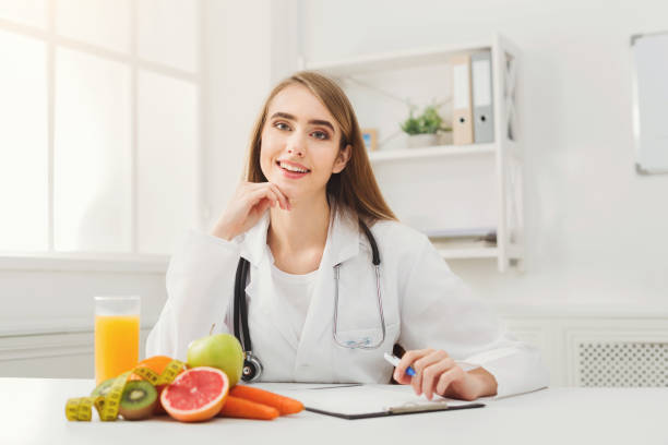 istock Nutritionist desk with fruit and measuring tape 909049220