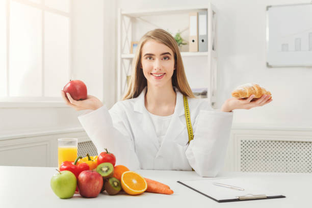 istock Dietitian nutritionist with bun and apple 909049284