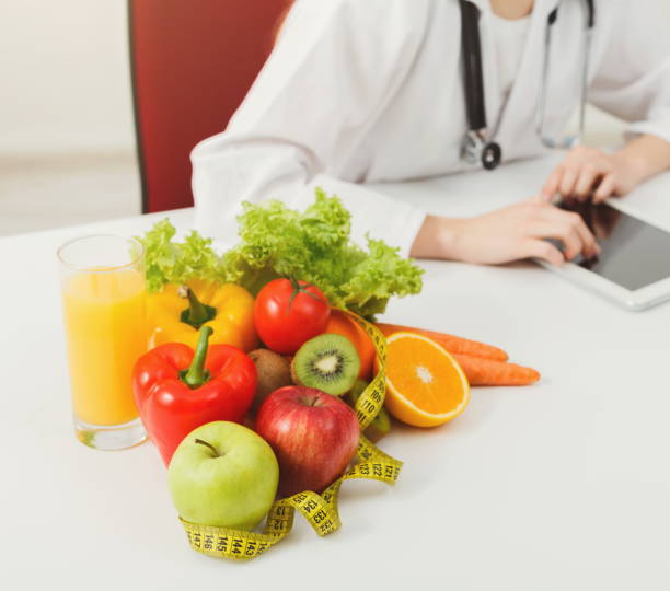 istock Female nutritionist working on digital tablet 909049352