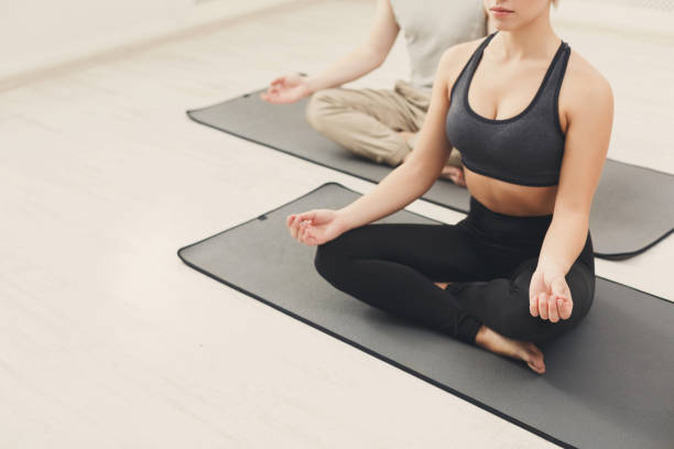 istock Young couple meditating together in studio 909049566