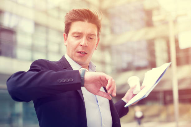 istock Man in jacket with documents hurrying to meeting 909053428