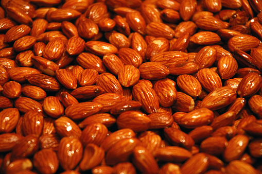 Dry fruits and almonds sold at a market stall.